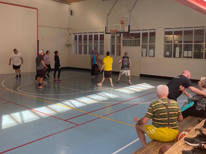 A basketball game is being played at the Y Streetball four year celebration.